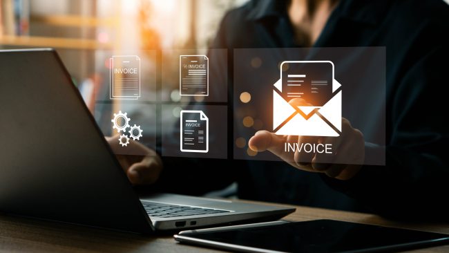 E-Invoice and Digital billing concept, Businessman using laptop to manage electronic statements on virtual screen. E-tax, Digital receipt, Online invoice processing and tax accounting solutions.